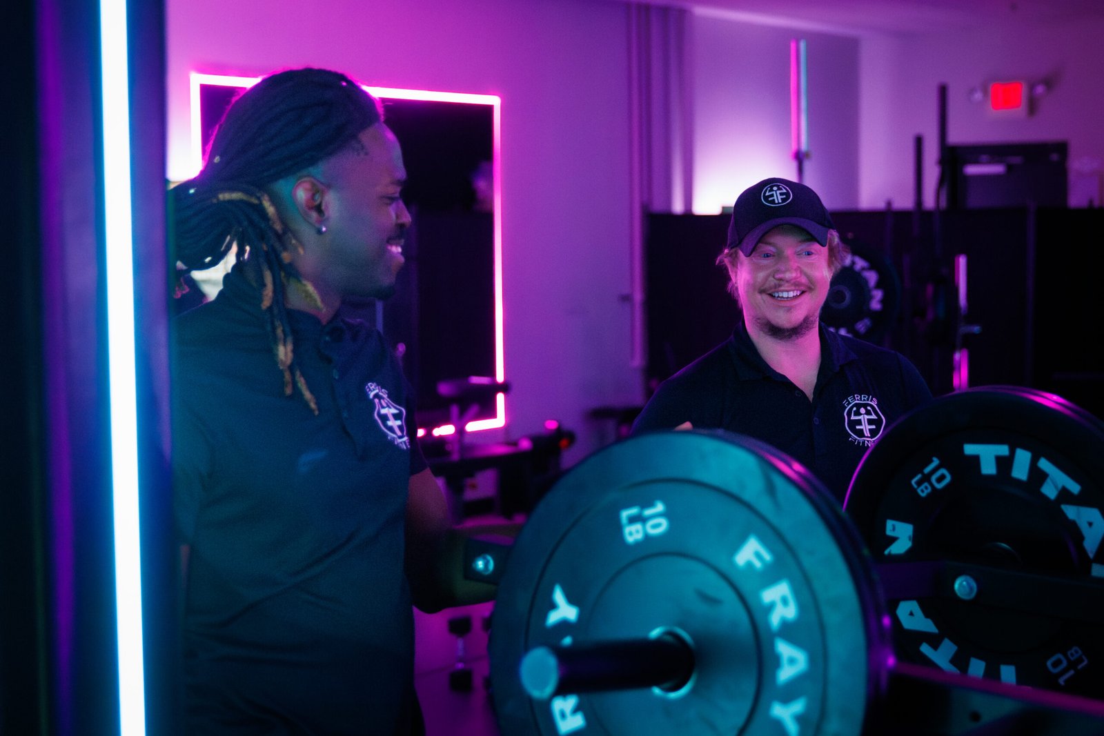 Member training with a weight plate at Ferris Fitness
