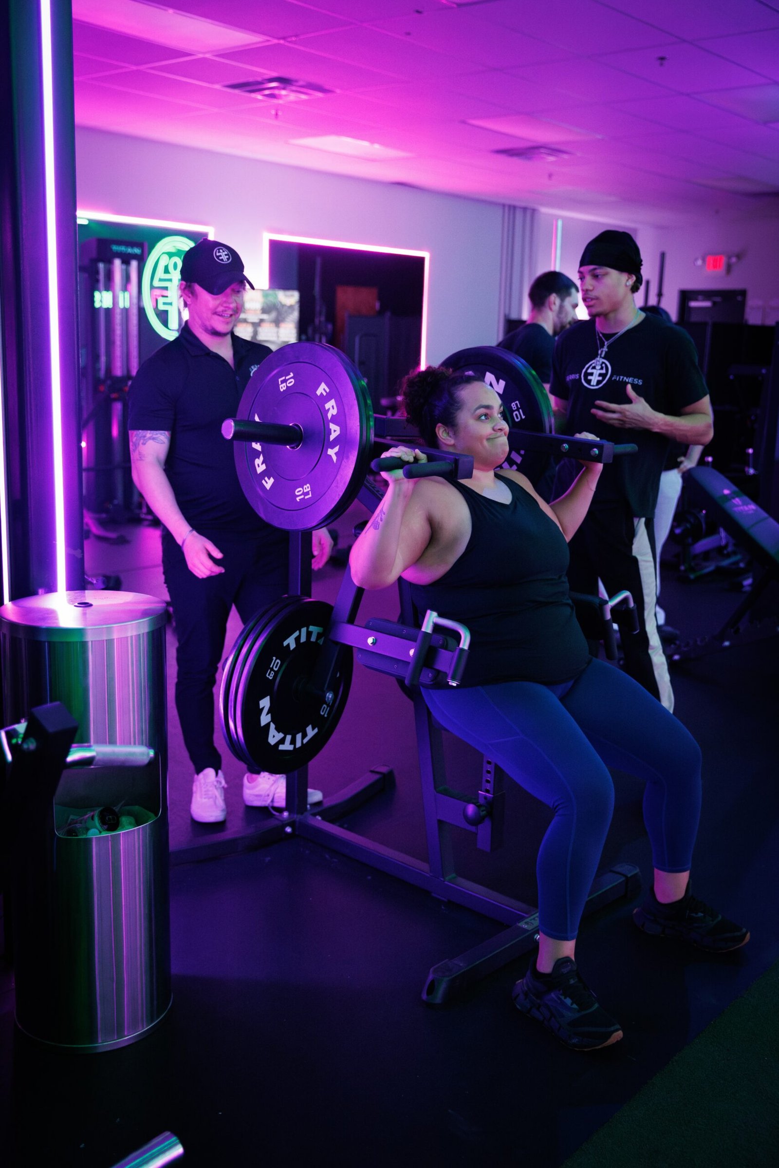 Coach spotting a member during a barbell squat at Ferris Fitness in Duluth, GA
